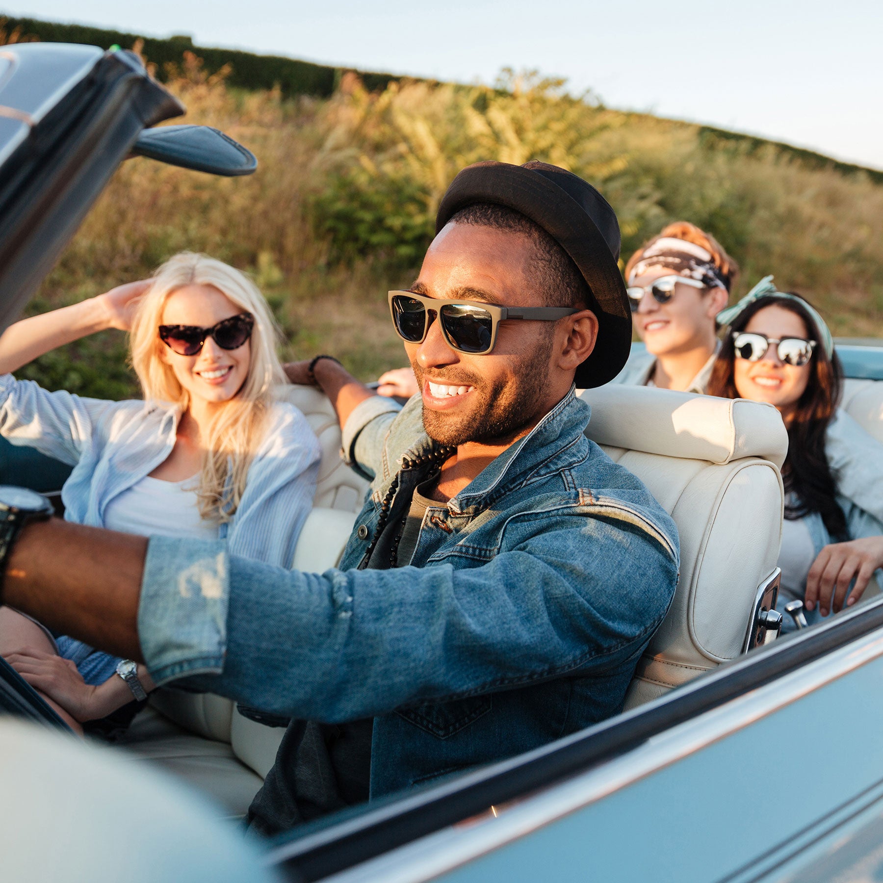 4 friends cruising in a convertable